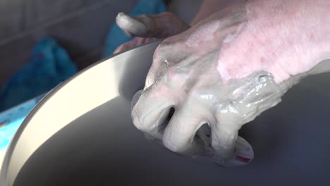 potters hands at work on a wheel