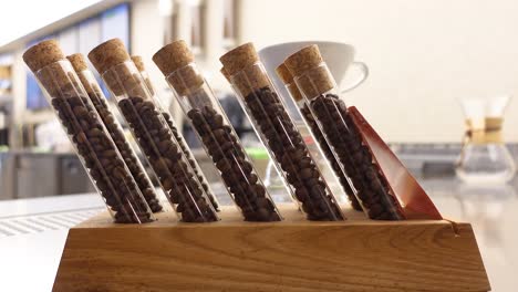 coffee beans in test tubes on a wooden rack