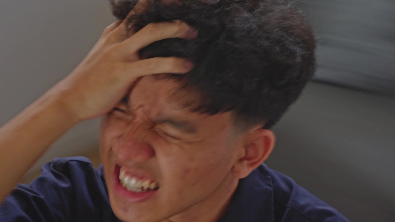 Extreme close-up POV spinning shot of Asian man violent vertigo or migraine attack