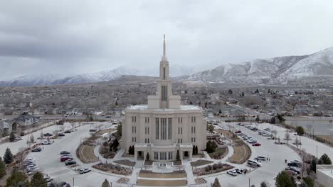 exterior of payson utah temple of the church of jesus christ of latter-day saints with snowy mountain at winter in background in payson, utah