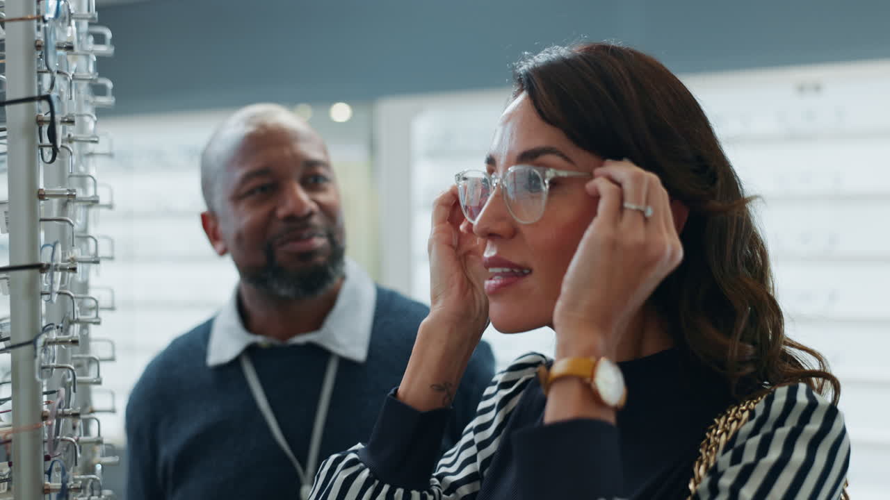 Woman trying on glasses at an opticians