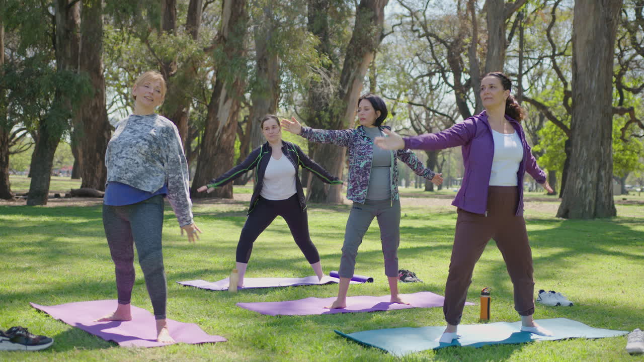 Group of Women Practicing Yoga Outdoors