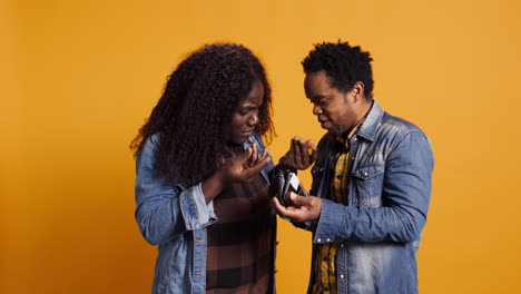 African-american-married-couple-looking-for-money-inside-the-leather-wallet