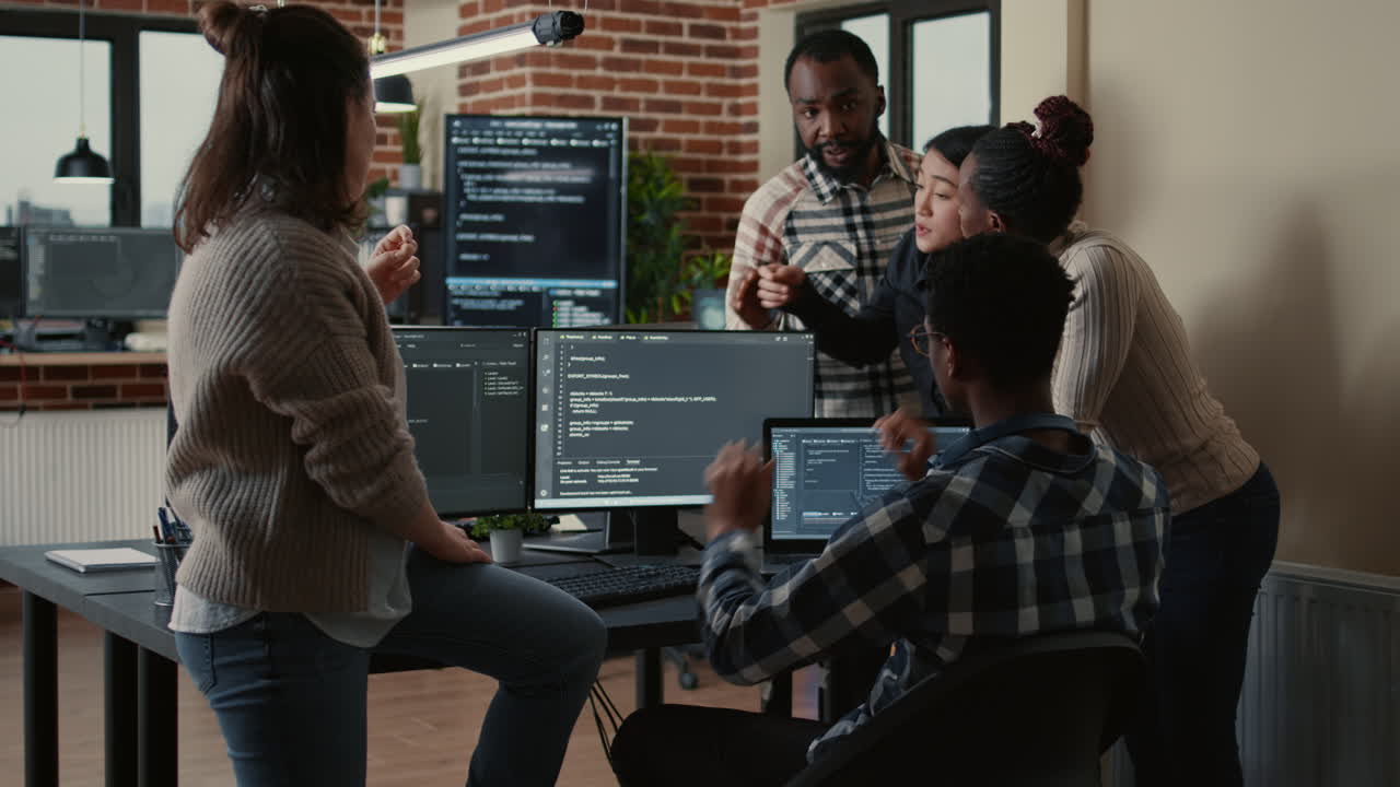 Software developers discussing about source code compiling discovers errors and asks the rest of the team for explanations