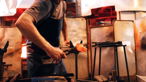 glassblower shaping a molten glass