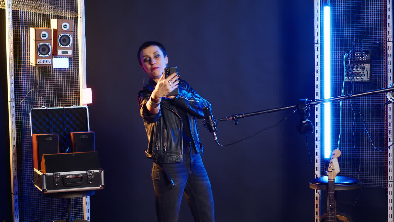 Image of a woman taking a selfie on stage