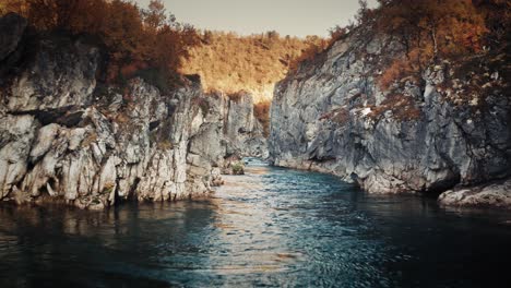 Bird's-eye-view-of-the-mountain-river-flowing-slowly-in-the-deep-narrow-canyon