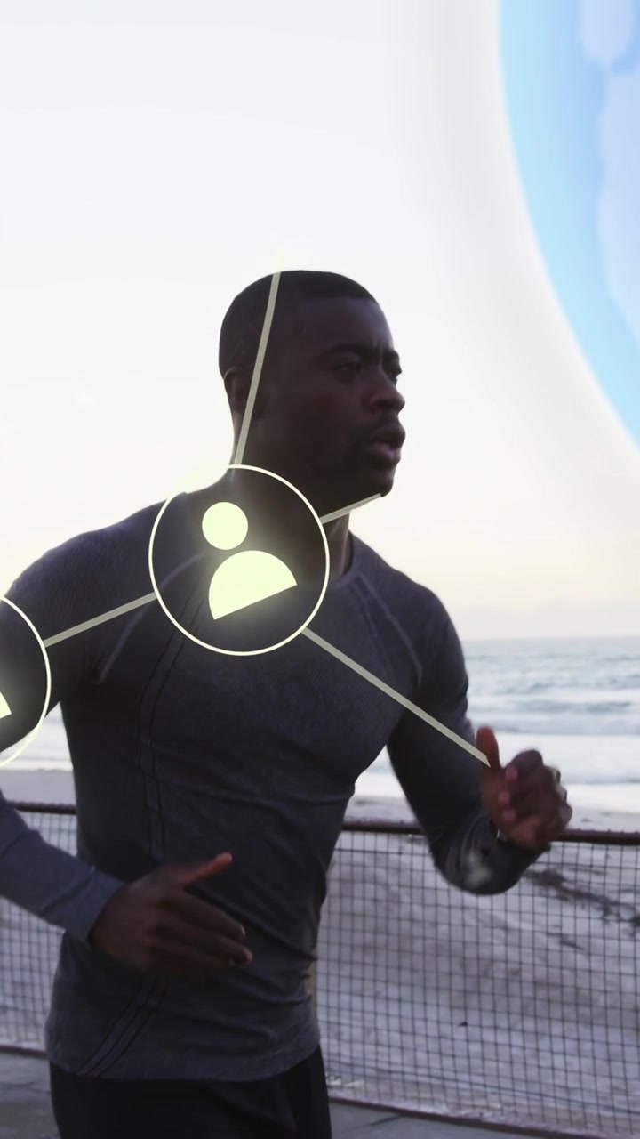 Vertical video: Man jogging seafront cam panning causing icons and globe around runner showing tech