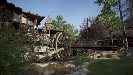 Slider-shot-of-an-old-water-wheel-on-a-river-in-a-small-mountain-town-in-Colorado