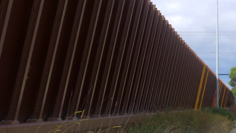 pan right, traffic noise barrier along a freeway