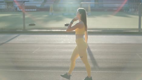 woman running on outdoor track in yellow sportswear