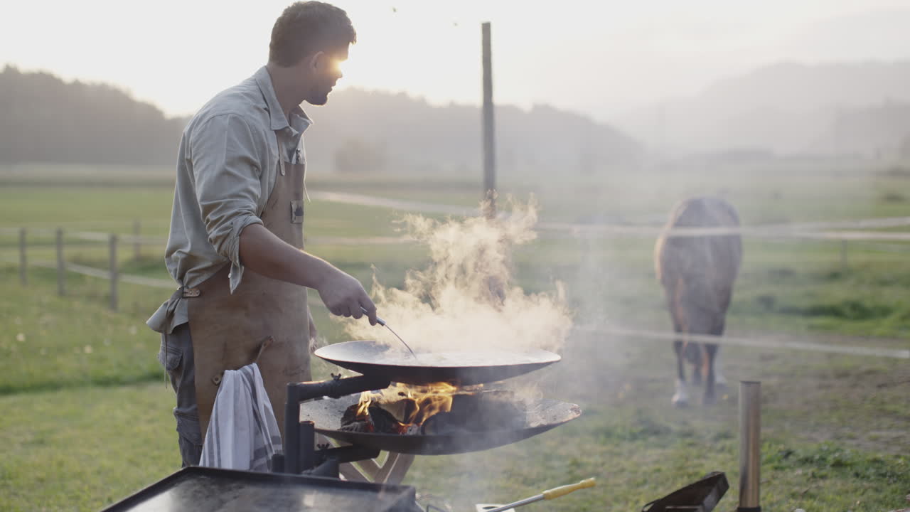 Man Grilling Outdoors by a Farm