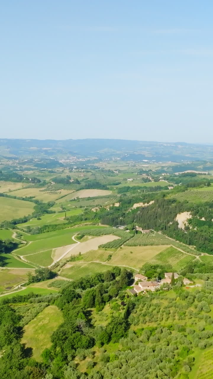 Aerial portrait shot over a idyllic tuscan countryside landscape, summer in Italy