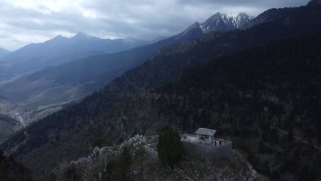 flying over an observatory in the mountains with snowy peaks in the distance | 4k