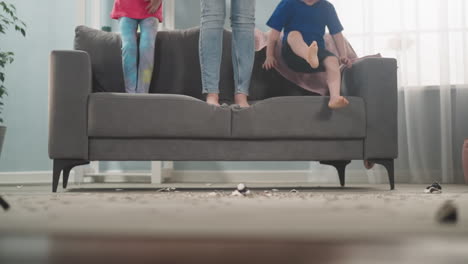 little boy gets down of sofa jumping amazed by coins amount