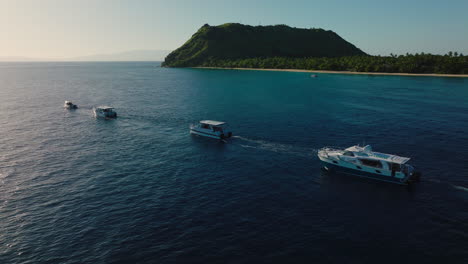 soft golden light bathes ocean bay with anchored boats and distant island silhouettes
