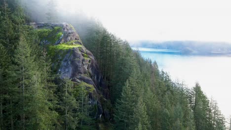 scenic shot of quarry rock on a foggy day in deep cove, north vancouver with the indian arm in the background