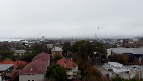 Aerial---drone-shot-of-rooftops-and-hazy-city-skyline