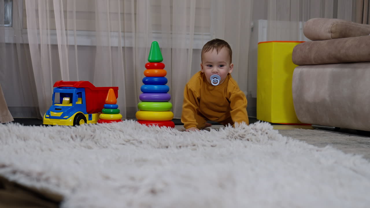 Baby playing with toys on the carpet