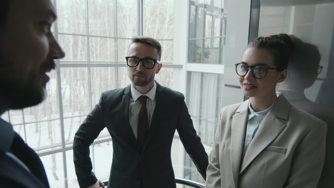 Team of Lawyers Going Up in Elevator