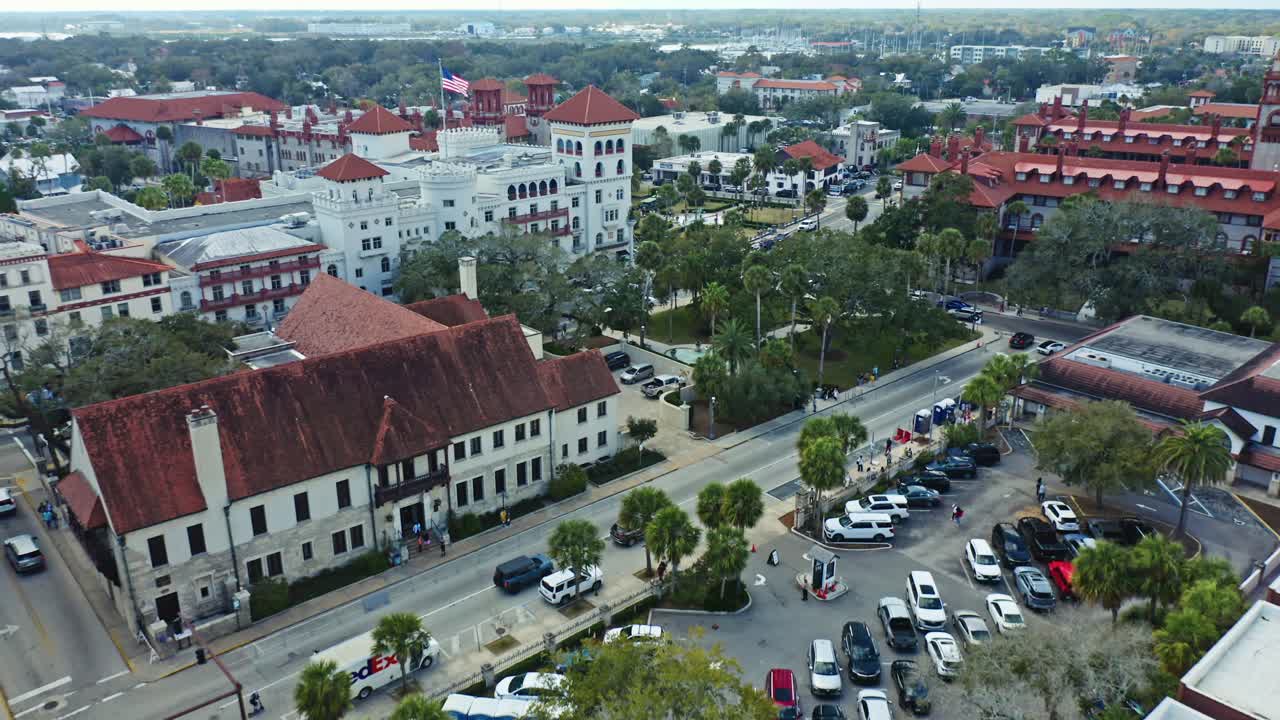 Quartiere storico di St. Augustine, Florida, con edifici simbolo dai tetti rossi, vegetazione lussureggiante e strade con auto parcheggiate e percorsi pedonali