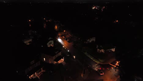 aerial view of cars driving on a residential street at night