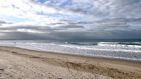 Slow motion pan at the sea with waves at a cloudy day
