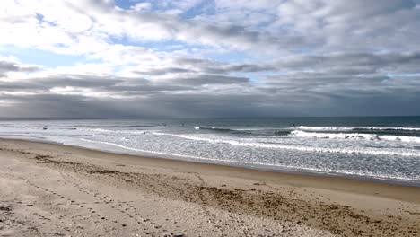 slow motion pan at the sea with waves at a cloudy day