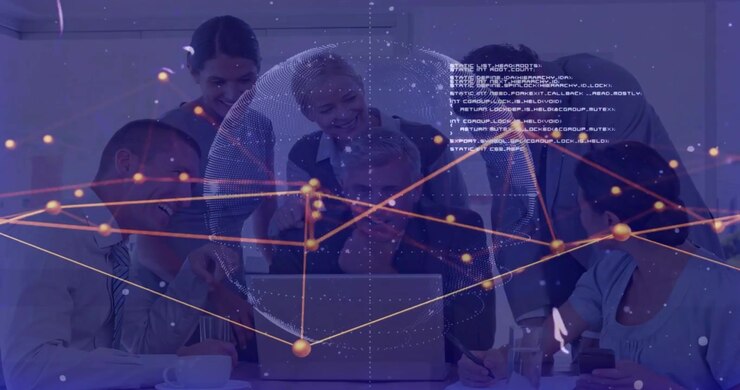 Et team på seks læner sig over en bærbar computer, initierer en prikket globus og et knudepunktsnet, der visualiserer forretningsdata.