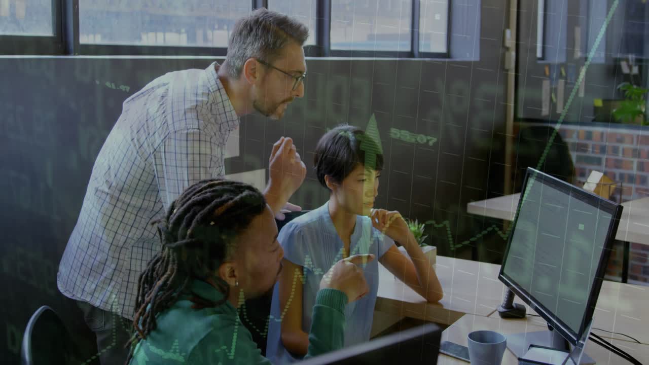 Team lead leaning forward and pointing at upward financial chart on monitor, colleagues analyzing
