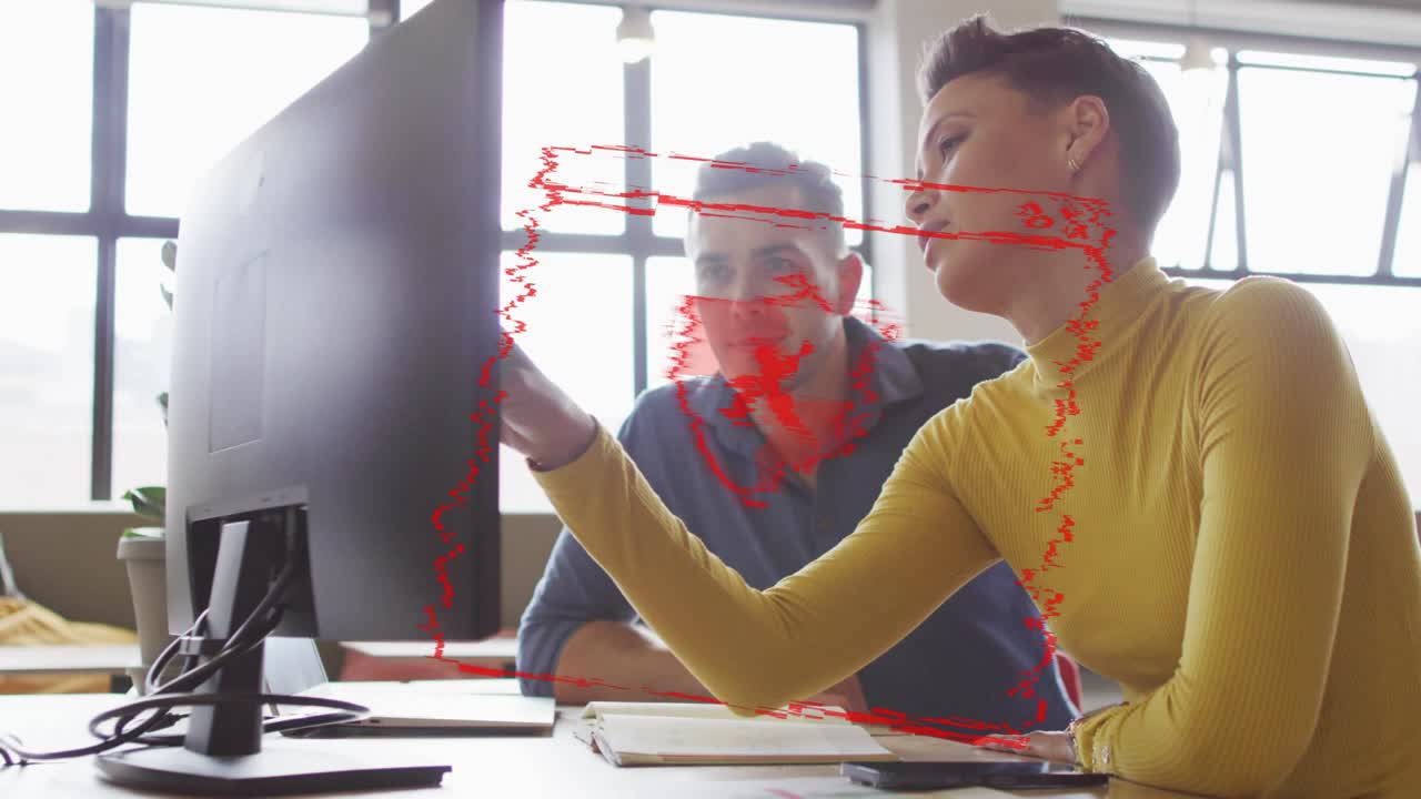 Woman pointing at monitor as red SYSTEM HACKED alert emerging IT coworker leaning, stopping breach