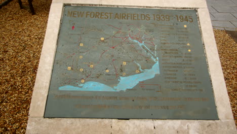 panning mid shot of the memorial plaque showing the map of the airfields at the new forest airfields memorial in the new forest