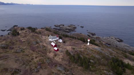 Aerial-shot-of-a-old-historical-lighthouse-located-at-the-coast-near-Sorvagen-in-Moskenes,-Lofoten