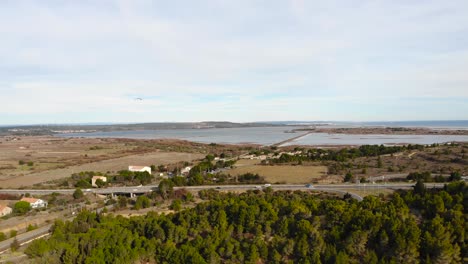 Aerial:-main-road-with-light-traffic-in-southern-France-with-the-Mediterranena-sea-in-the-background