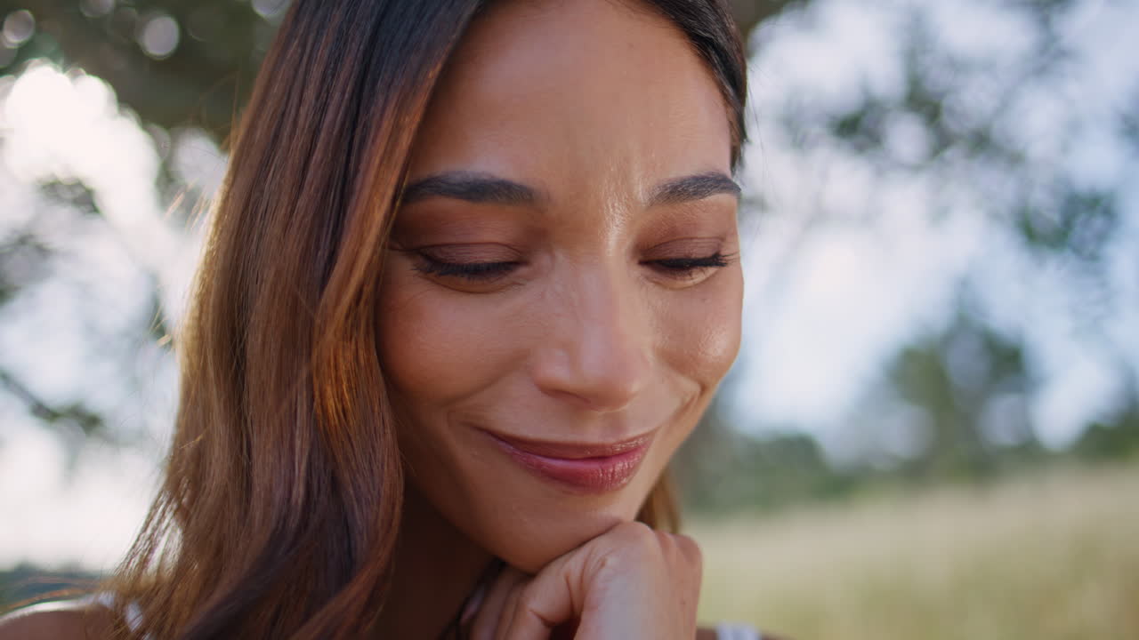 Laughing brunette resting nature portrait. Relaxed young woman looking camera