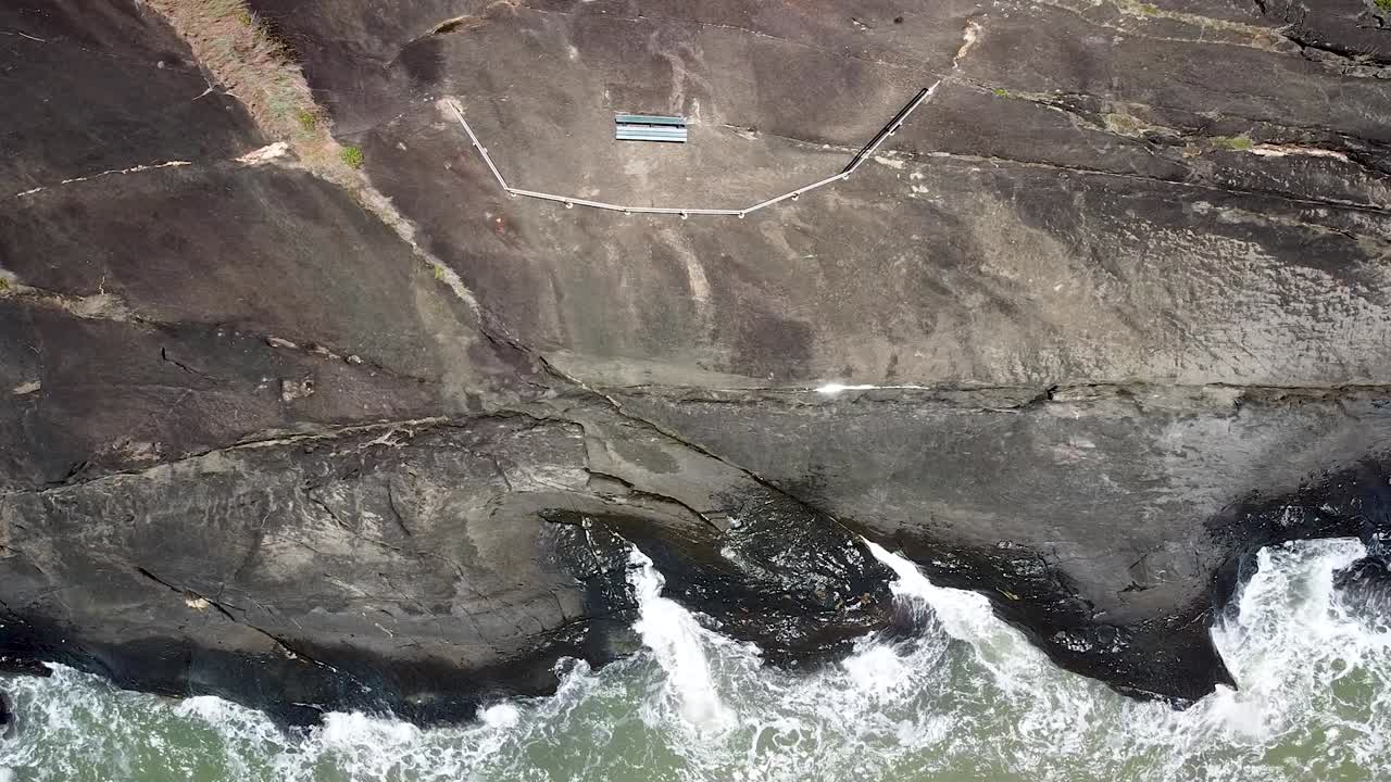 Aerial Of Waves Crashing Onto Rocks At Trinity Beach In Cairns