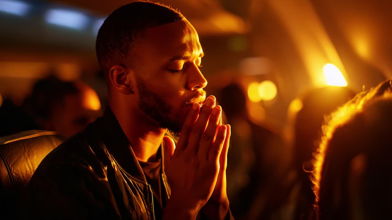 A Contemplative Moment: A Man in Deep Meditation and Reflection Amidst Low Light on an Airplane, Emphasizing Introspection and Quietude in a Crowd of Fellow Passengers
