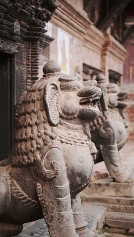 bhaktapur stone statue in a nepal temple, vertical video for social media instagram reels and tiktok close up detail of statues in bhaktapur ancient city holy and sacred religious place