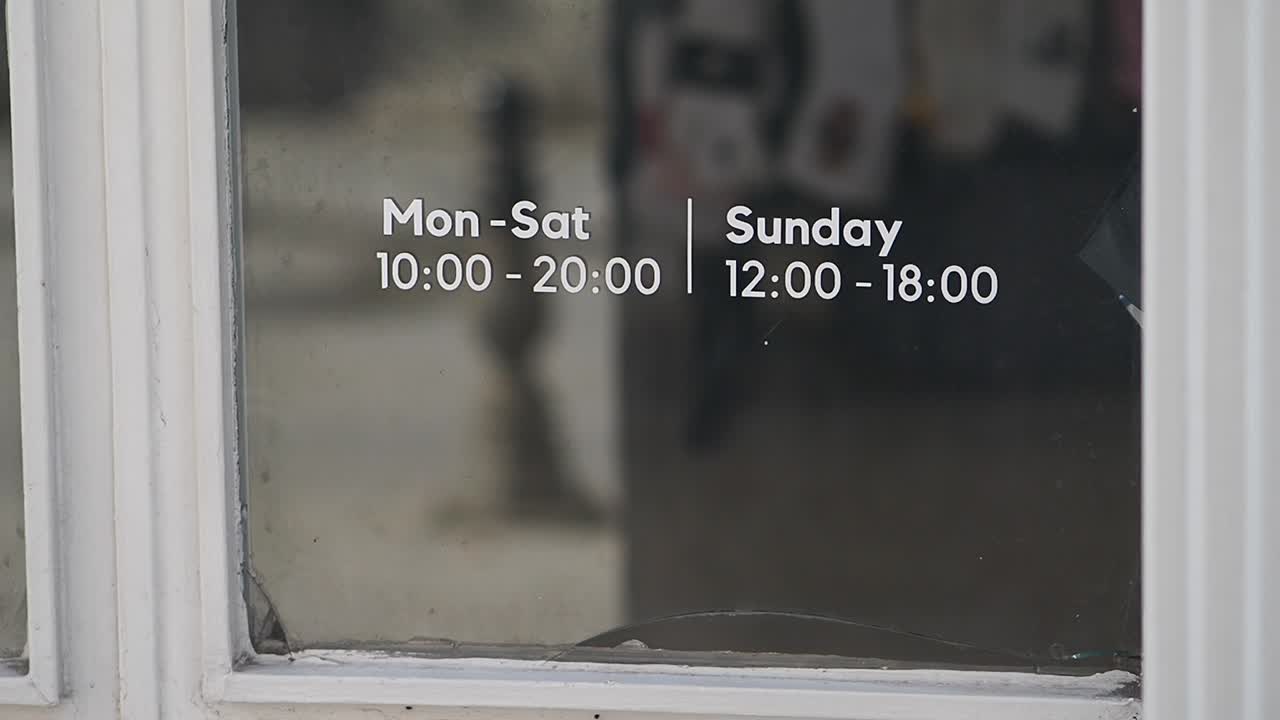 Business Operating Hours Sign on Glass Window