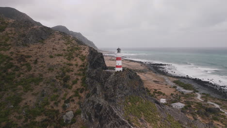 aerial view of lighthouse on rocky coastline, new zealand