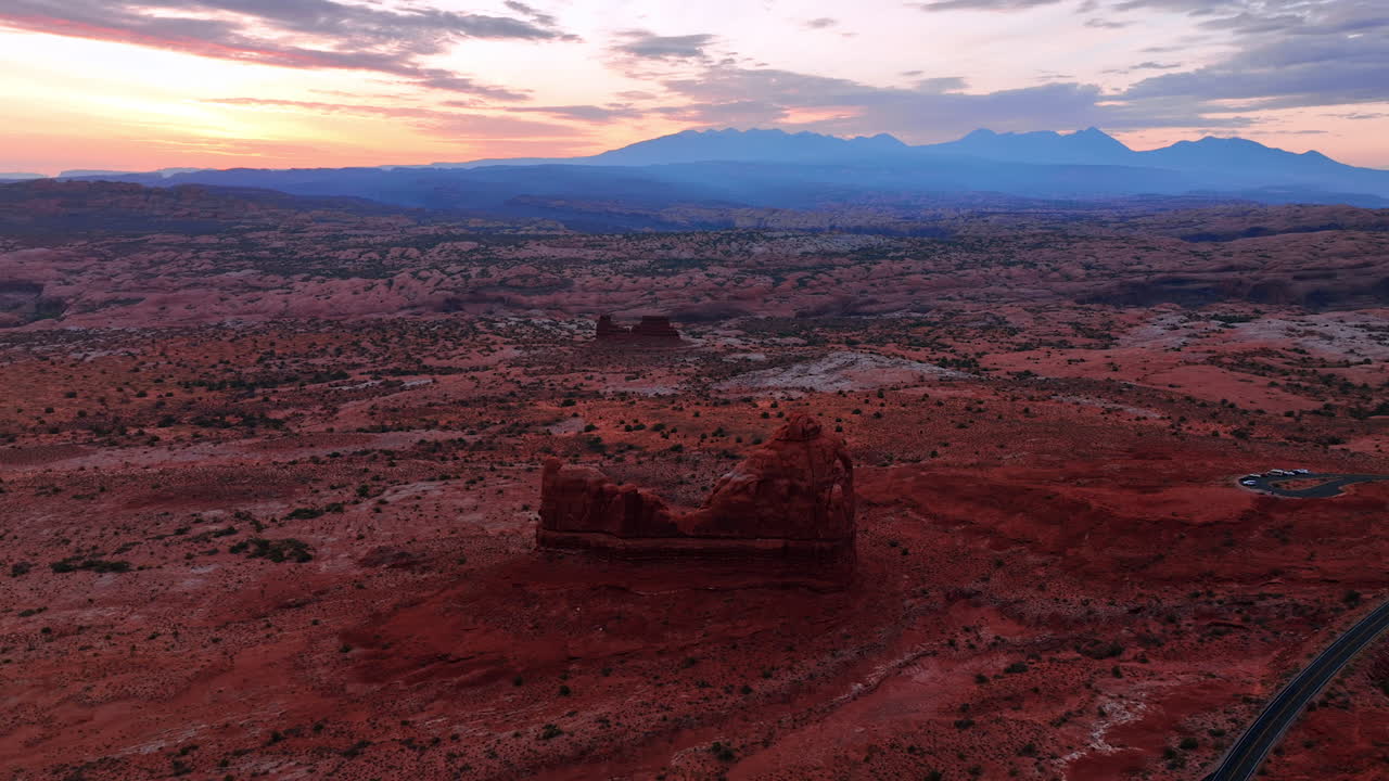 Amazingly beautiful sunset tine in the vast desert. Approaching the red rock among the deserted landscape in the Arches National Park in Utah, USA. Aerial perspective