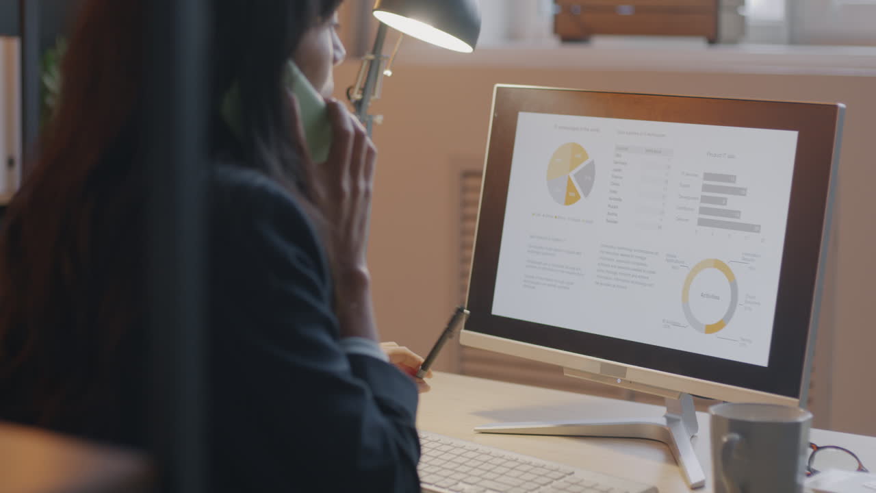 Businesswoman Discussing Data on Computer