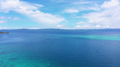 Picturesque-Landscape-Of-Blue-Sea-And-Cottages-At-Tagbak-Marine-Park-In-The-Philippines