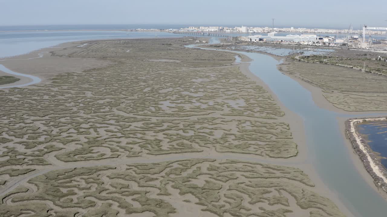 Aerial View of a Salt Marsh and Estuary with Industrial Cityscape