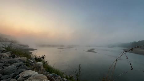 gloomy sunrise over the river in chitwan, nepal.