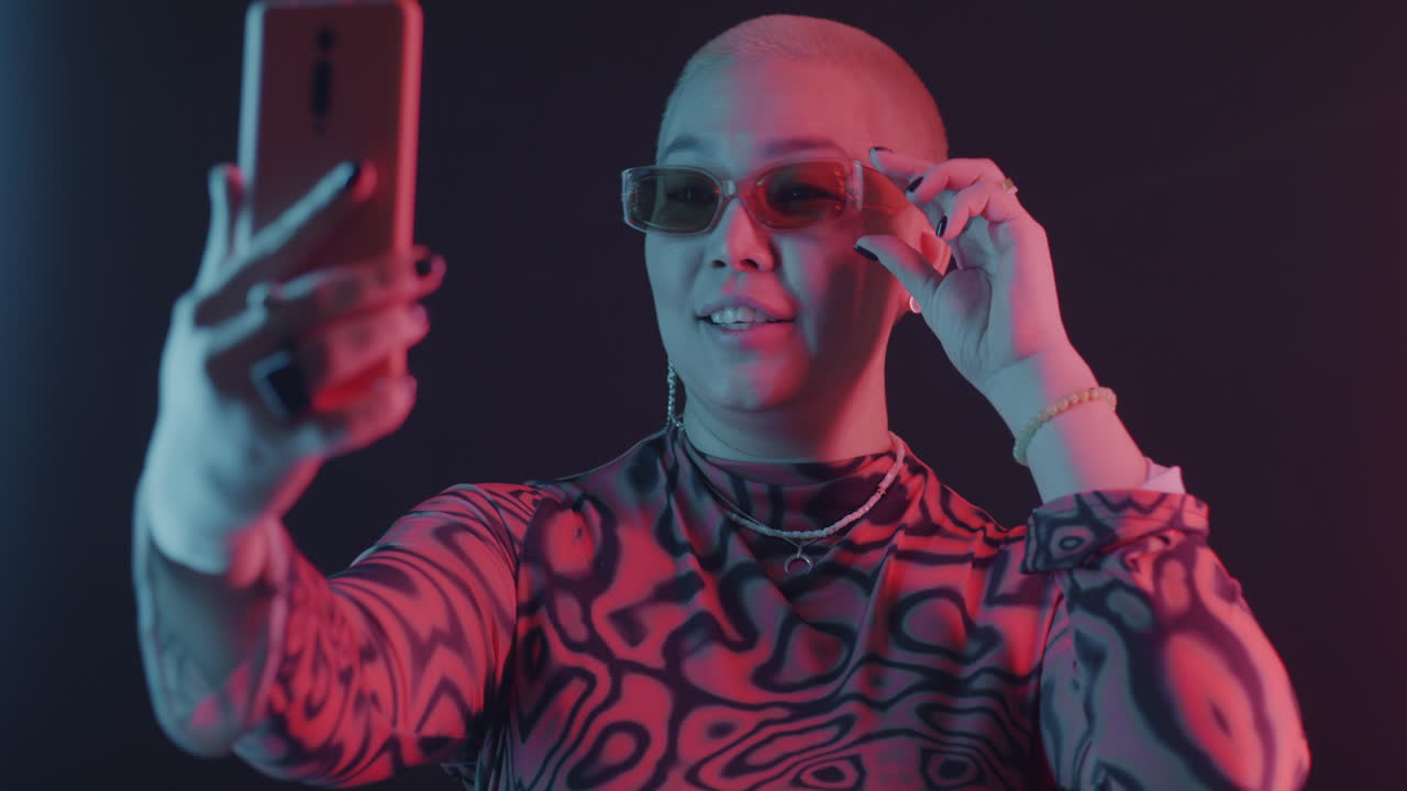 Stylish Woman Taking a Selfie in Neon Light