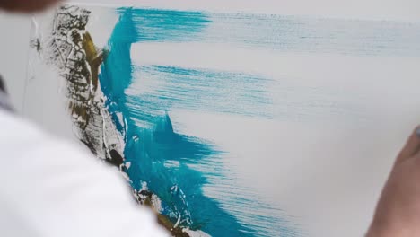 the restoration procedure of the painting. restorer artist restore paint on picture. close-up