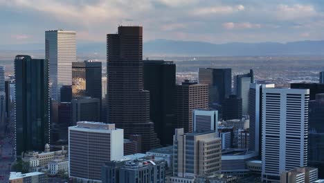 downtown denver cityscape city tall skyscraper buildings spring summer afternoon sunset mountains range landscape aerial drone colorado city park rhino pan clouds sunny panorama pan left motion