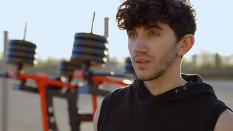 young man taking a break during outdoor workout