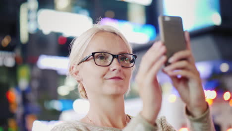 Woman-Filming-City-at-Night